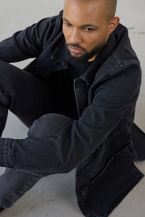 Nomen Nescio 320 Worker Denim Jacket washed black – editorial, model seated in full denim look